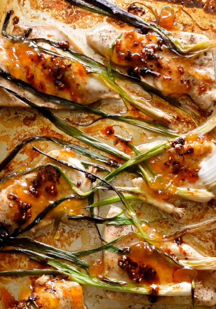 Chicken with sesame apricot sauce served with charred scallions