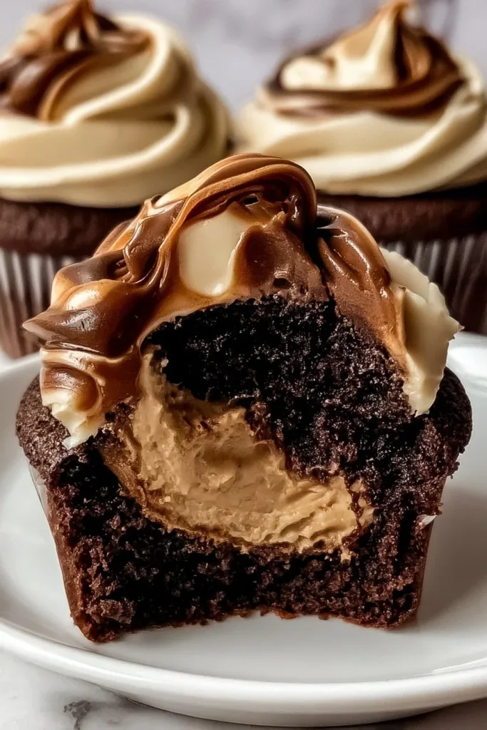 Delicious chocolate cupcakes with creamy coffee frosting on top.