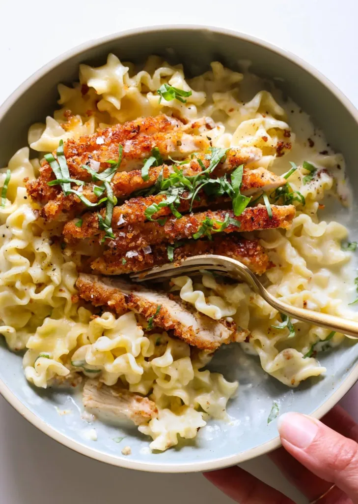 Crispy Parmesan Chicken plated with garnish and sides