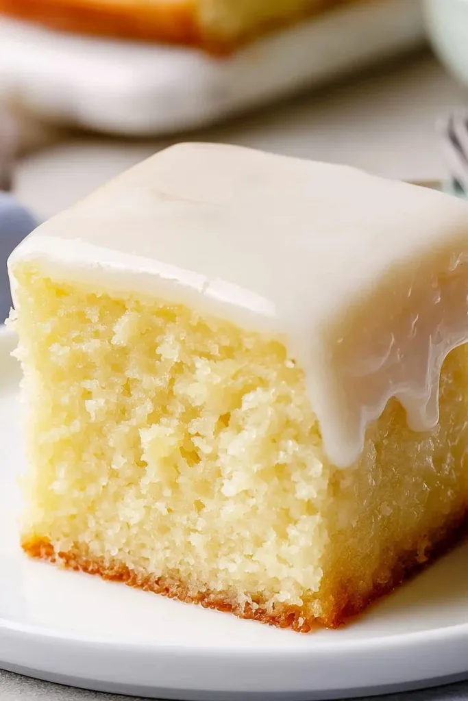 Delicious homemade lemonade cake topped with fresh lemon slices.
